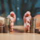 Divorce law and inheritance separation concept. Hand separate saving money, finance, home loan, debt return. Bank business investment. Man separate stack coin, wood house on table. Inherit division